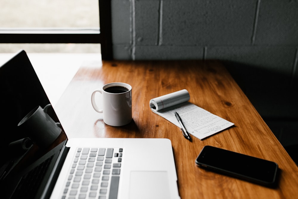 Writing desk with laptop and notes